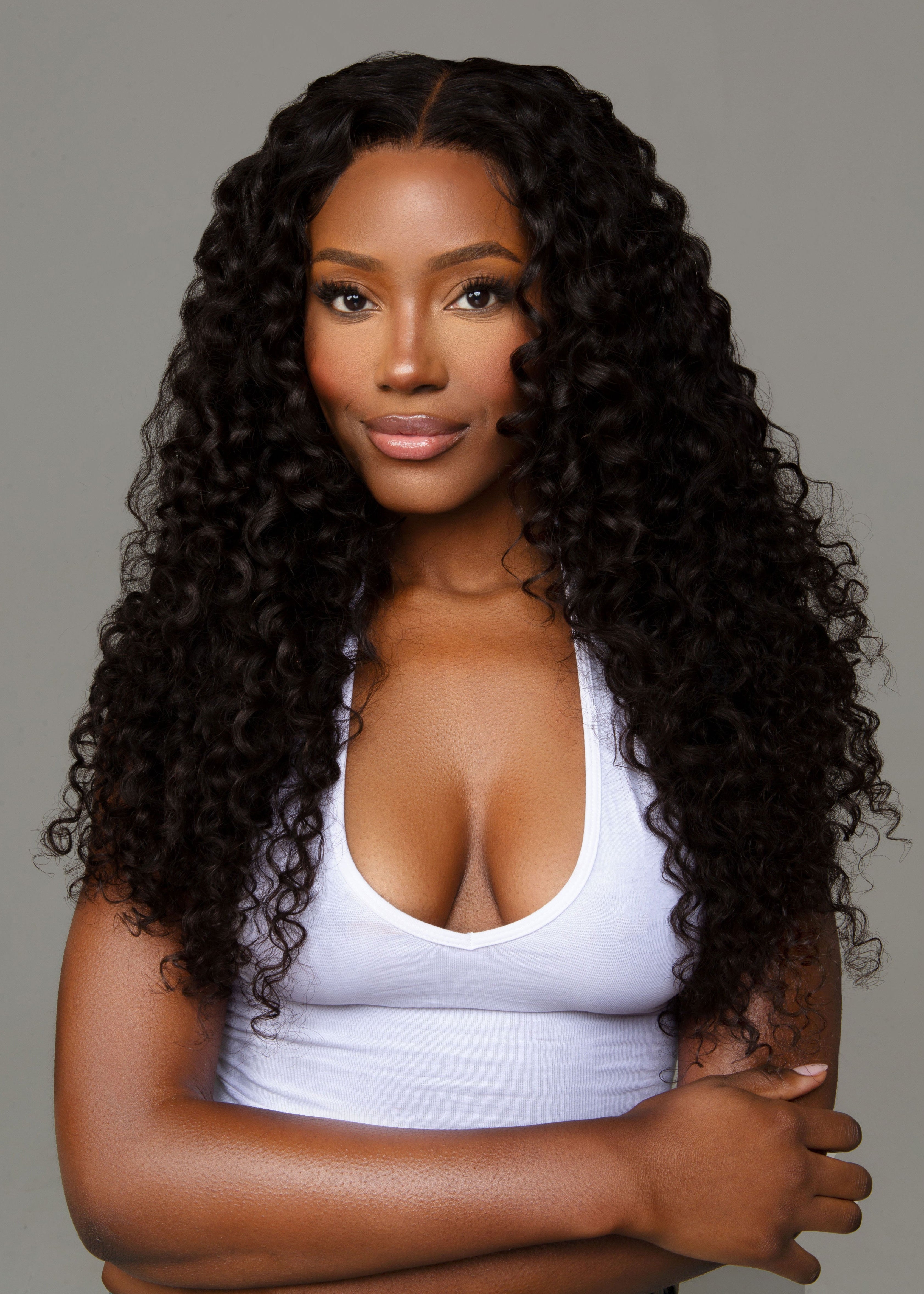 Black woman wearing curly peruvian hair extensions